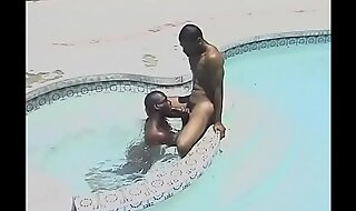 Black dude bends over to get a wet rimming in the pool