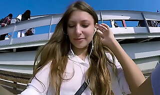 Talia mint plays in public with remote control toy over the phone with fan
