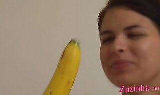 How-to young brunette girl teaches using a banana