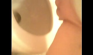 Girl with hairless pussy caught peeing on bathroom camera