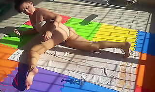 An attractive lady is sunbathing on the roof of her house nude yoga teaser 1